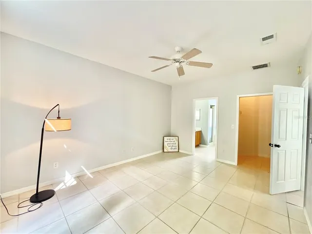 a view of a livingroom with a furniture and chandelier fan