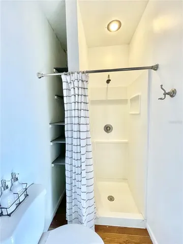 a bathroom with a shower and a sink