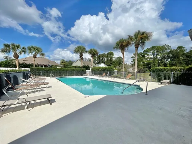 a view of a swimming pool with a table and chairs