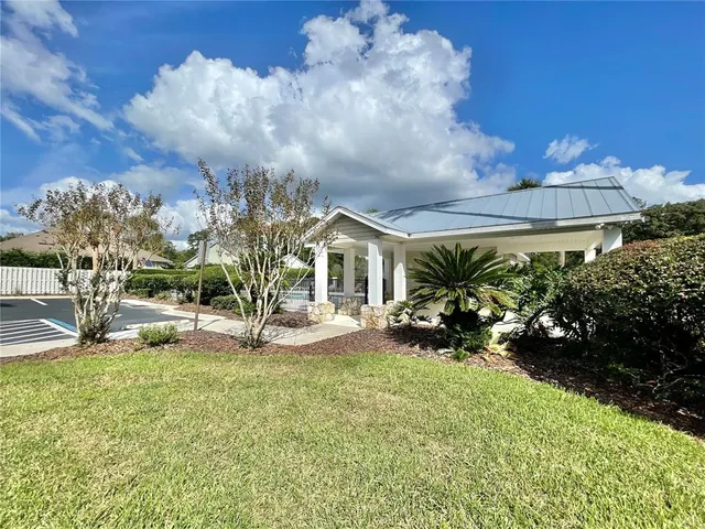 a view of a house with sitting area and garden