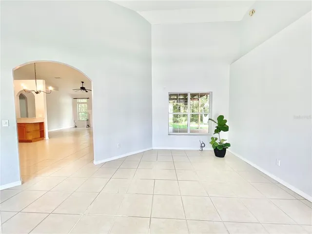 a view of hallway with a window and a chandelier