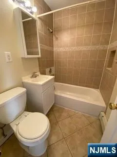 a bathroom with a toilet a sink and bathtub