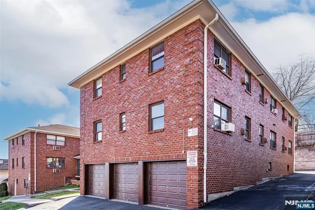 a front view of a building with parking space