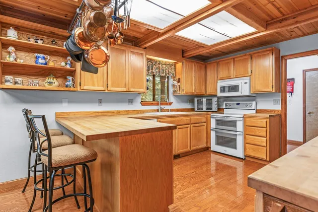 a kitchen with stainless steel appliances granite countertop a sink and cabinets