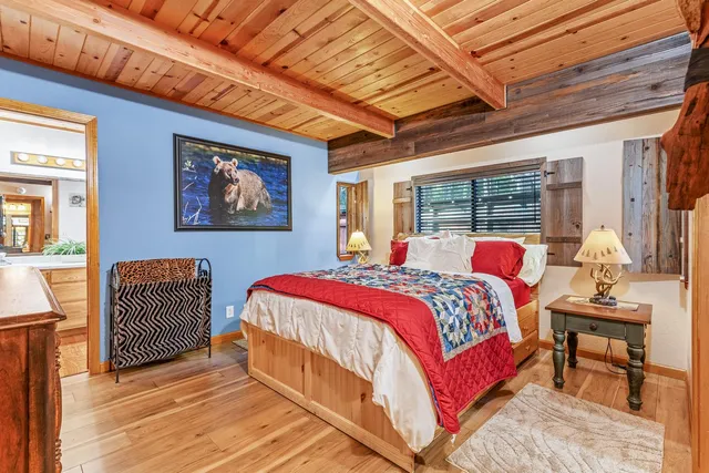 a bathroom with a granite countertop sink a toilet and a mirror
