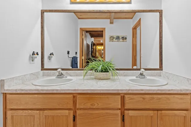 a bathroom with a toilet a sink and mirror