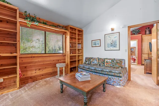 a bathroom with a granite countertop toilet a sink and a mirror