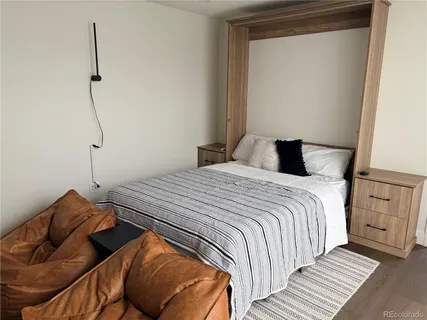 a bedroom with a bed and a night stand