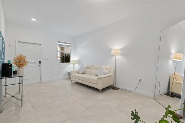 a living room with furniture and a lamp