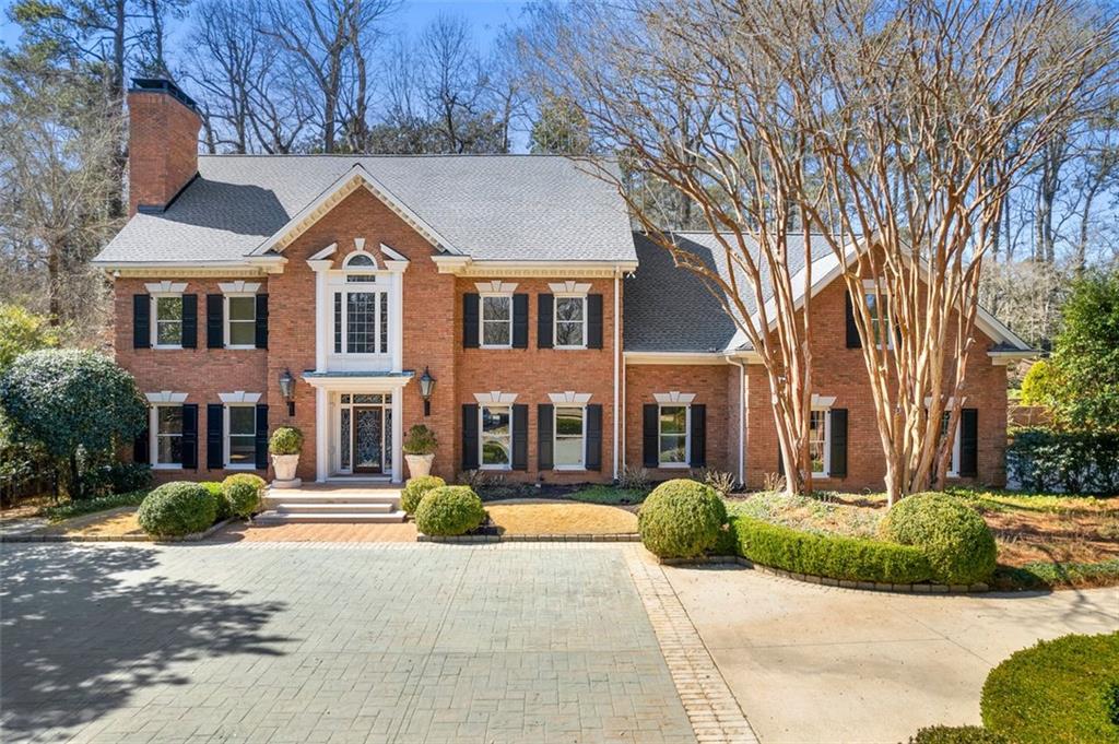 3864 Dumbarton Road Northwest Atlanta, GA 30327 - Photo 1 of 1 a front view of a house with a yard
