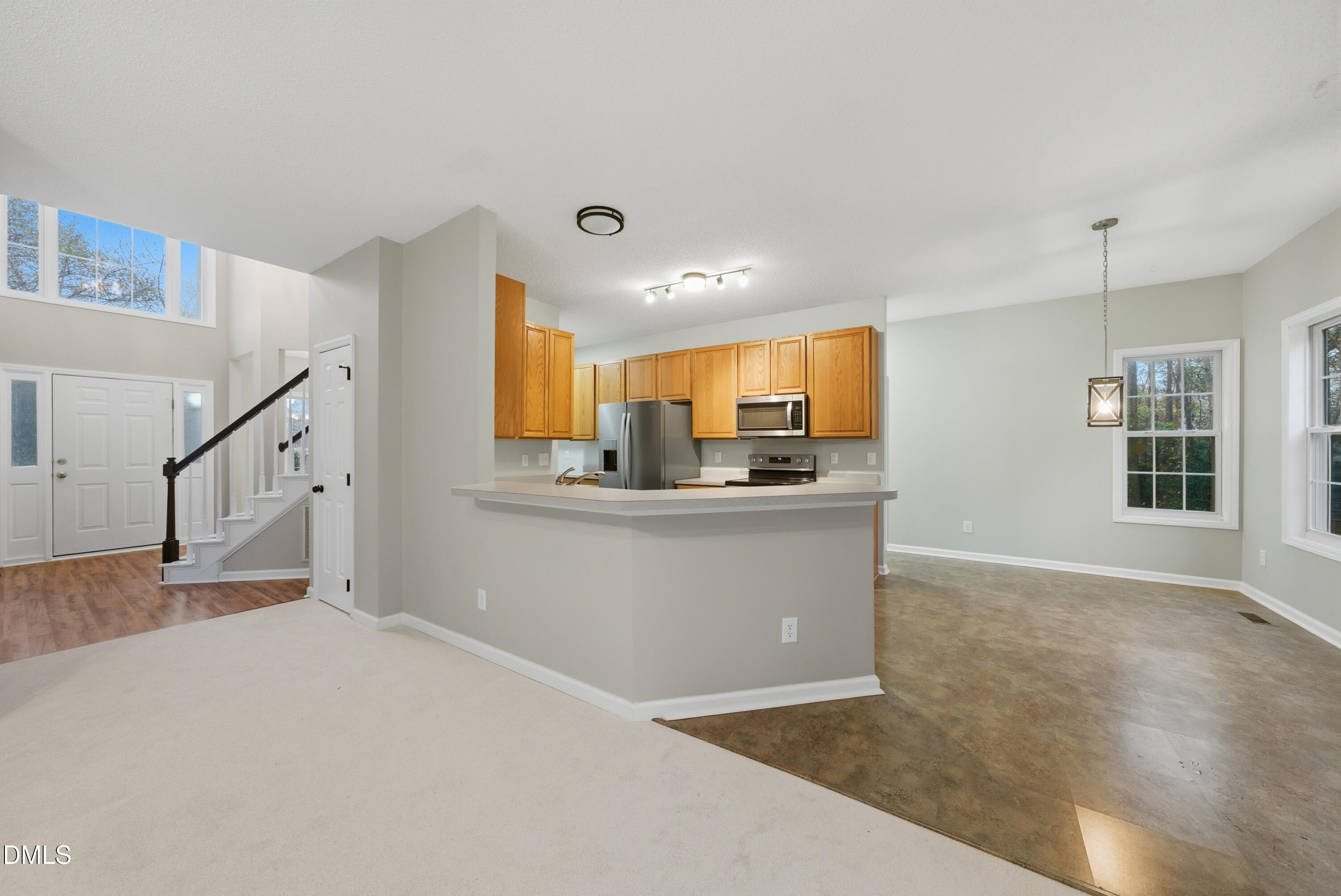 3100 Countryman Court Wake Forest, NC 27587 - Photo 13 of 42 a view of kitchen and hall with wooden floor and windows