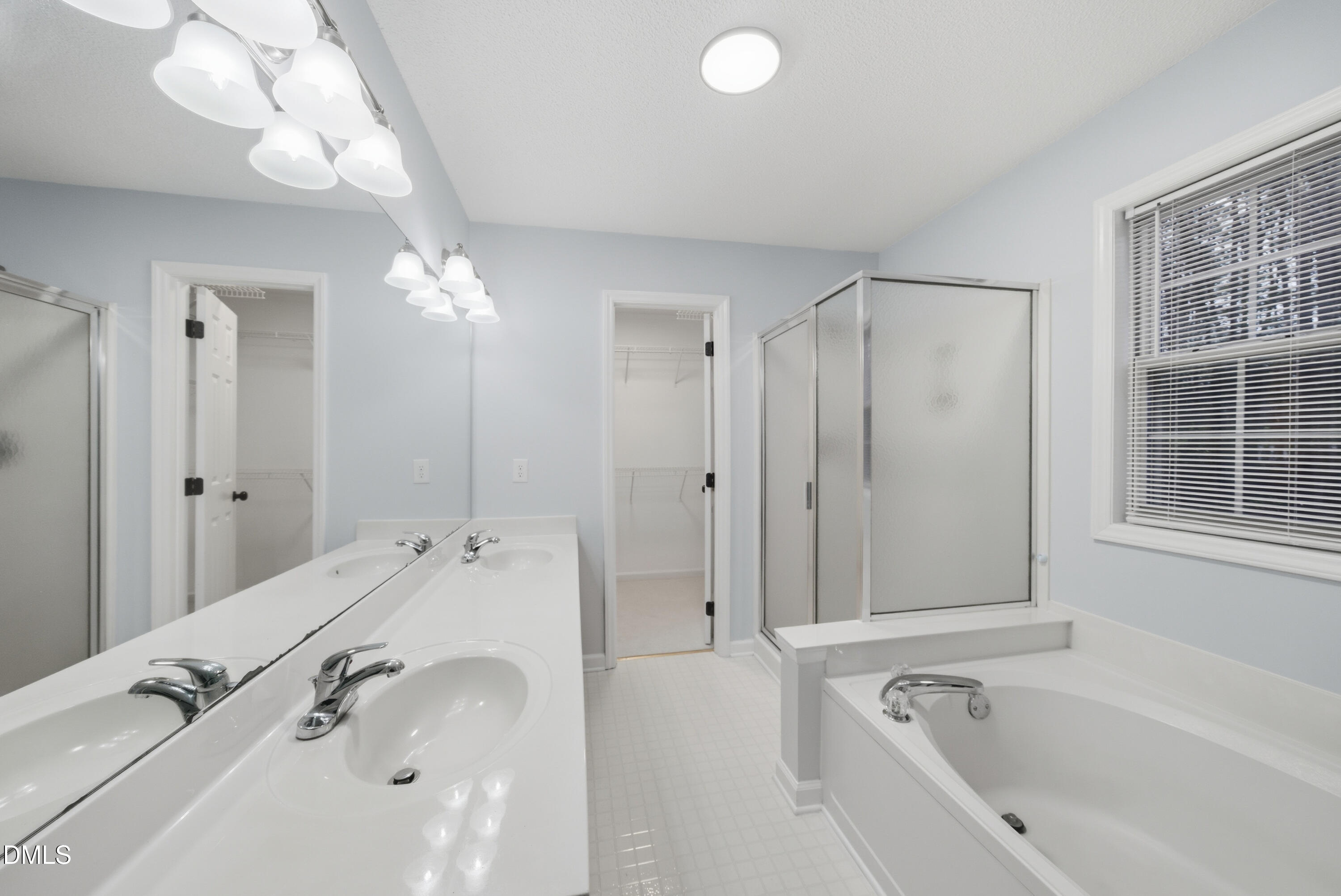 3100 Countryman Court Wake Forest, NC 27587 - Photo 27 of 42 a spacious bathroom with a tub a sink and mirror