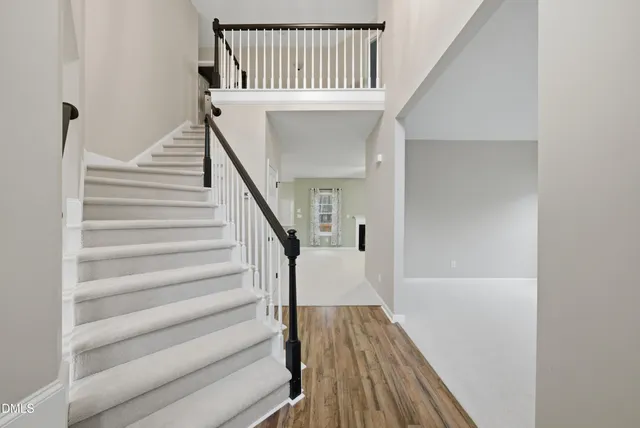 a view of a house with backyard and a tree