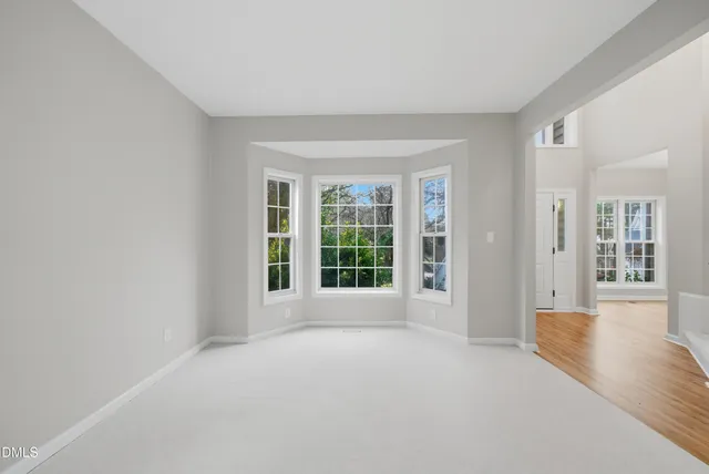 a view of a room with wooden floor and a window