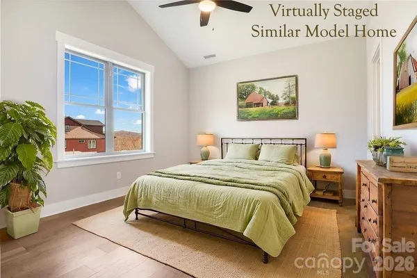 a bedroom with a bed and a potted plant