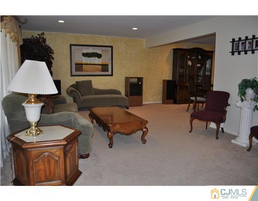 24 Fox Hill Road Edison, NJ 08820 - Photo 3 of 10 a living room with furniture and a lamp