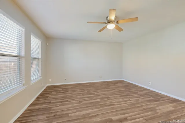 wooden floor in an empty room with a window
