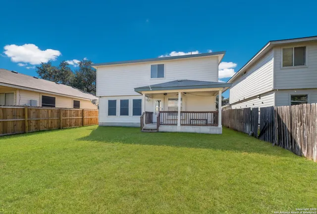 a view of a house with a yard and sitting area
