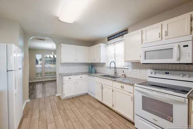 a kitchen with a sink stove and cabinets