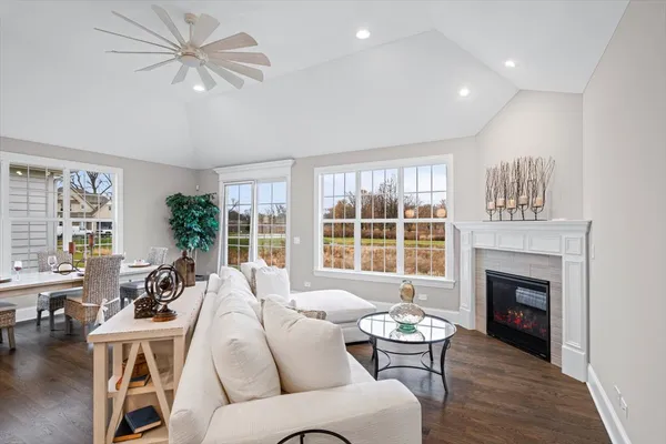 a living room with furniture a fireplace and a large window
