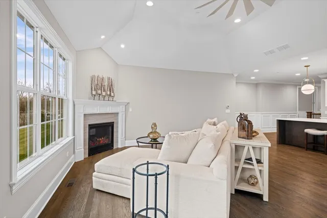 a living room with furniture a fireplace and wooden floor