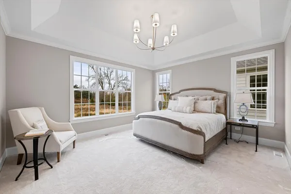 a bedroom with a bed chair and window