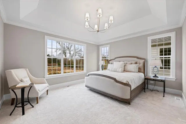 a bedroom with a bed chair and window