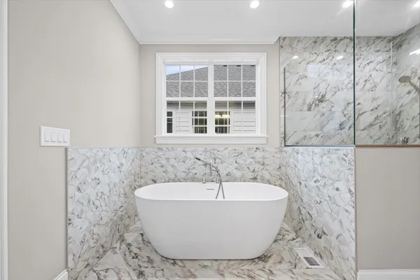 a bathroom with a granite countertop sink a toilet and shower