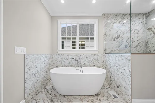 a bathroom with a granite countertop sink a toilet and shower