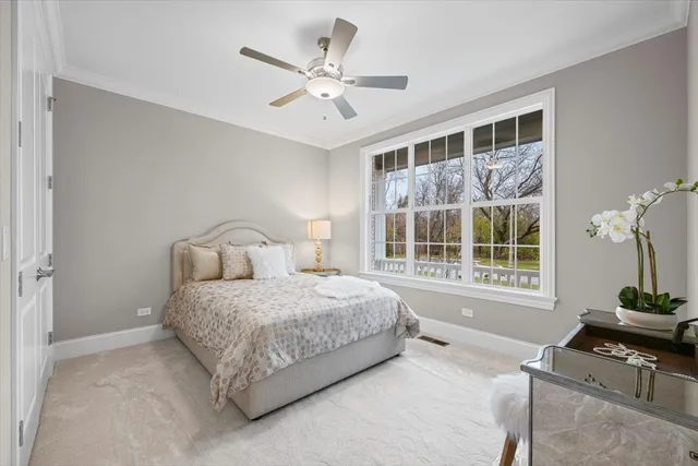a spacious bedroom with a bed and a chandelier