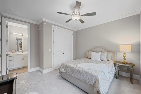 a spacious bedroom with a bed and a large window