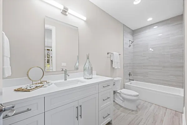 a spacious bathroom with a double vanity sink and a window