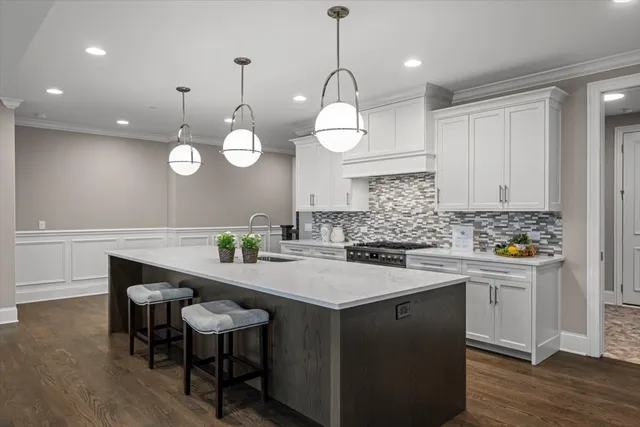 a kitchen with a sink cabinets and wooden floor