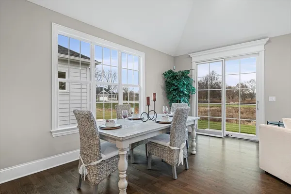 a dining room with furniture window and wooden floor