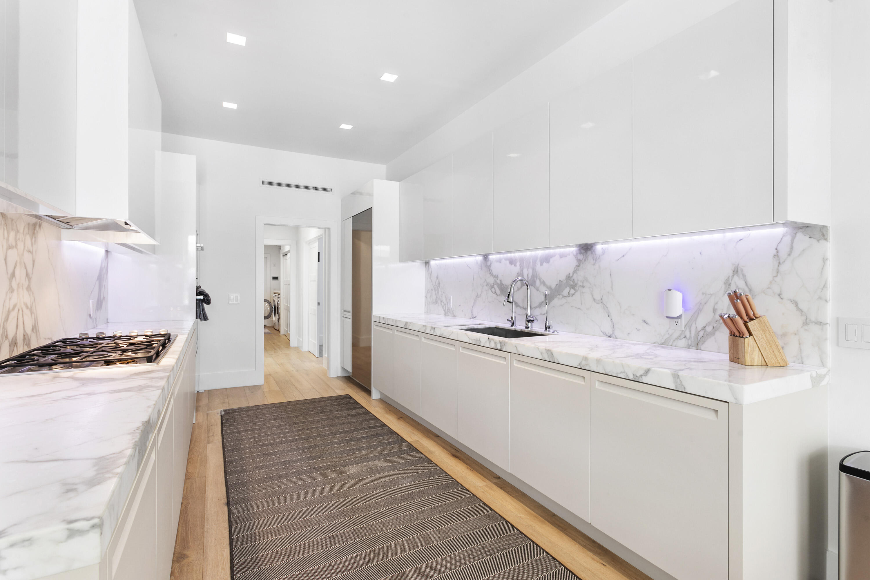 215 Island Drive Jupiter, FL 33477 - Photo 11 of 39 a kitchen with granite countertop a refrigerator and a stove