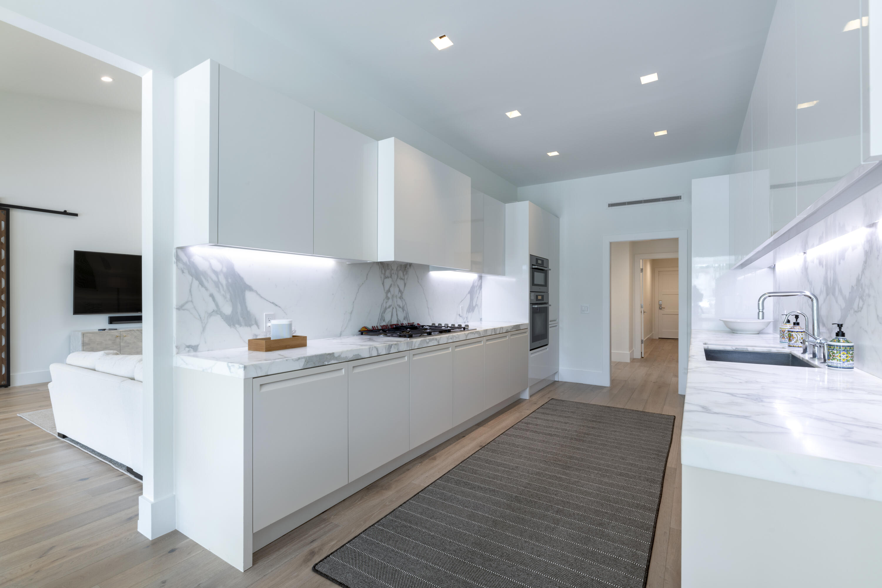 215 Island Drive Jupiter, FL 33477 - Photo 13 of 39 a large white kitchen with kitchen island a sink a stove and a refrigerator