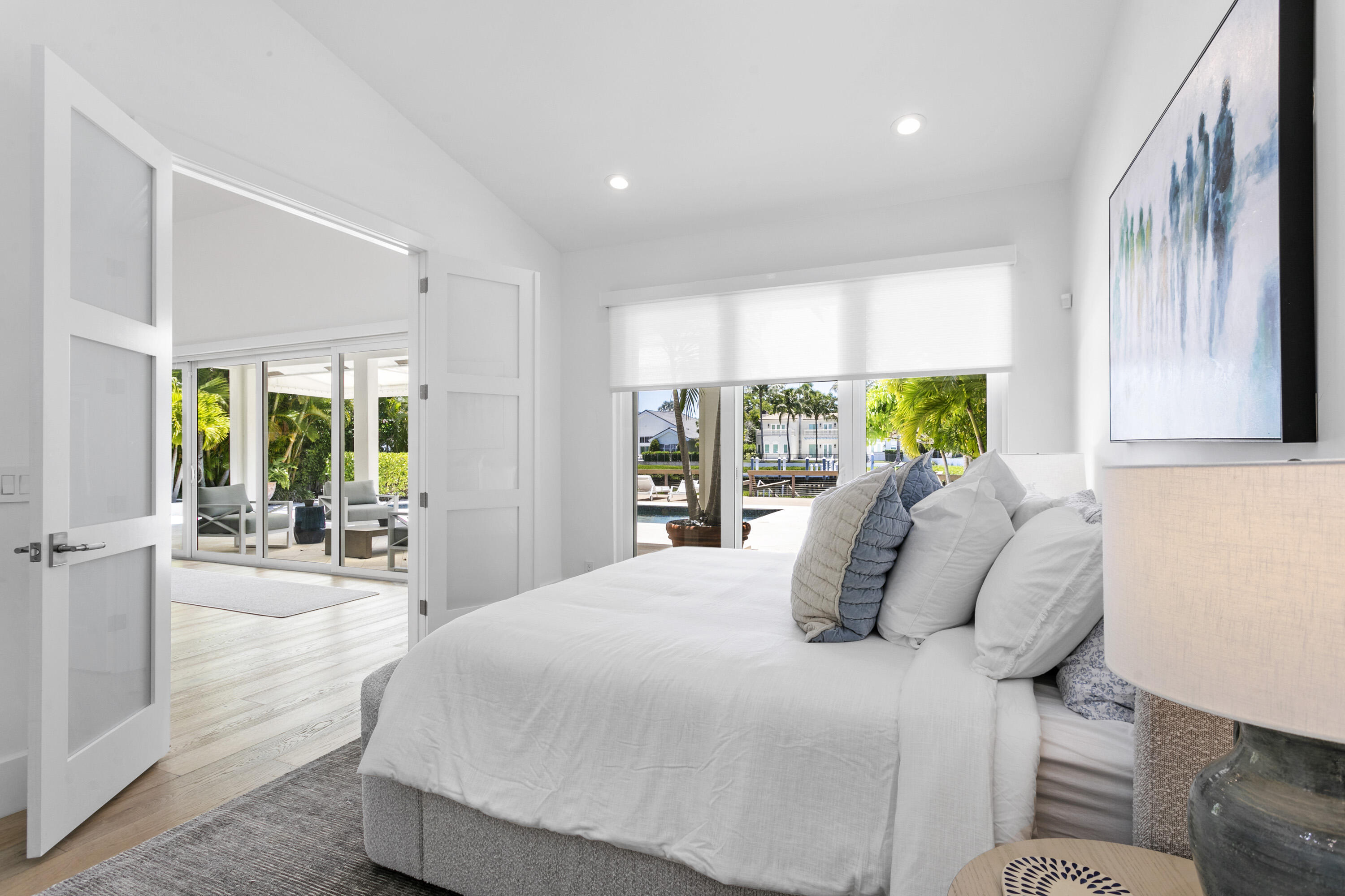 215 Island Drive Jupiter, FL 33477 - Photo 23 of 39 a bedroom with a bed and large windows