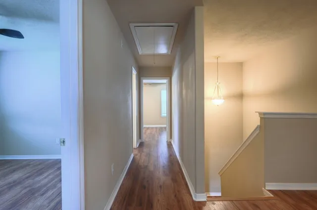 a view of a hallway with wooden floor