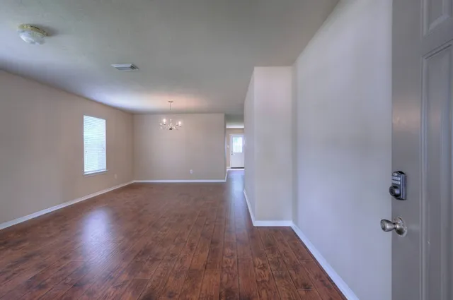 a view of a room with wooden floor and window