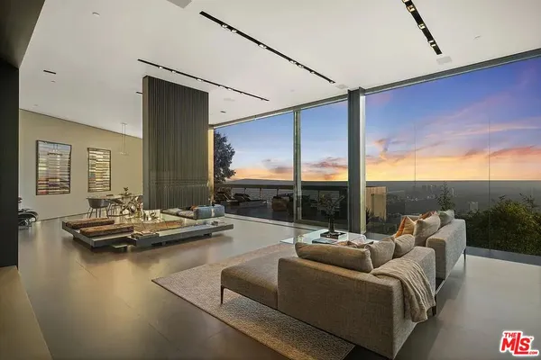 a living room with furniture and a floor to ceiling window