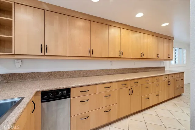 a kitchen with granite countertop white cabinets and sink