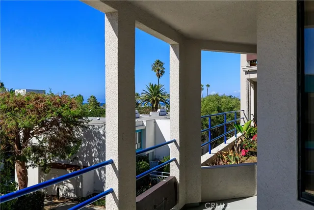 a view of a balcony with chairs and potted plants