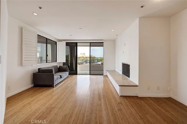a large living room with a fireplace and wooden floor