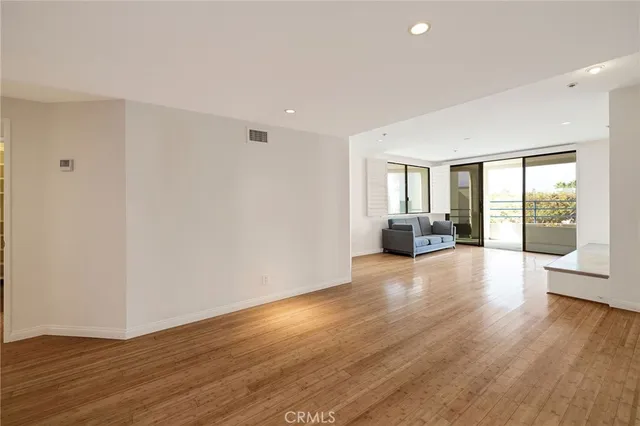 a view of a livingroom with furniture and hardwood floor