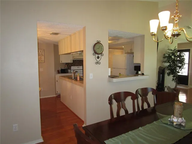 a kitchen with granite countertop a refrigerator and a stove top oven