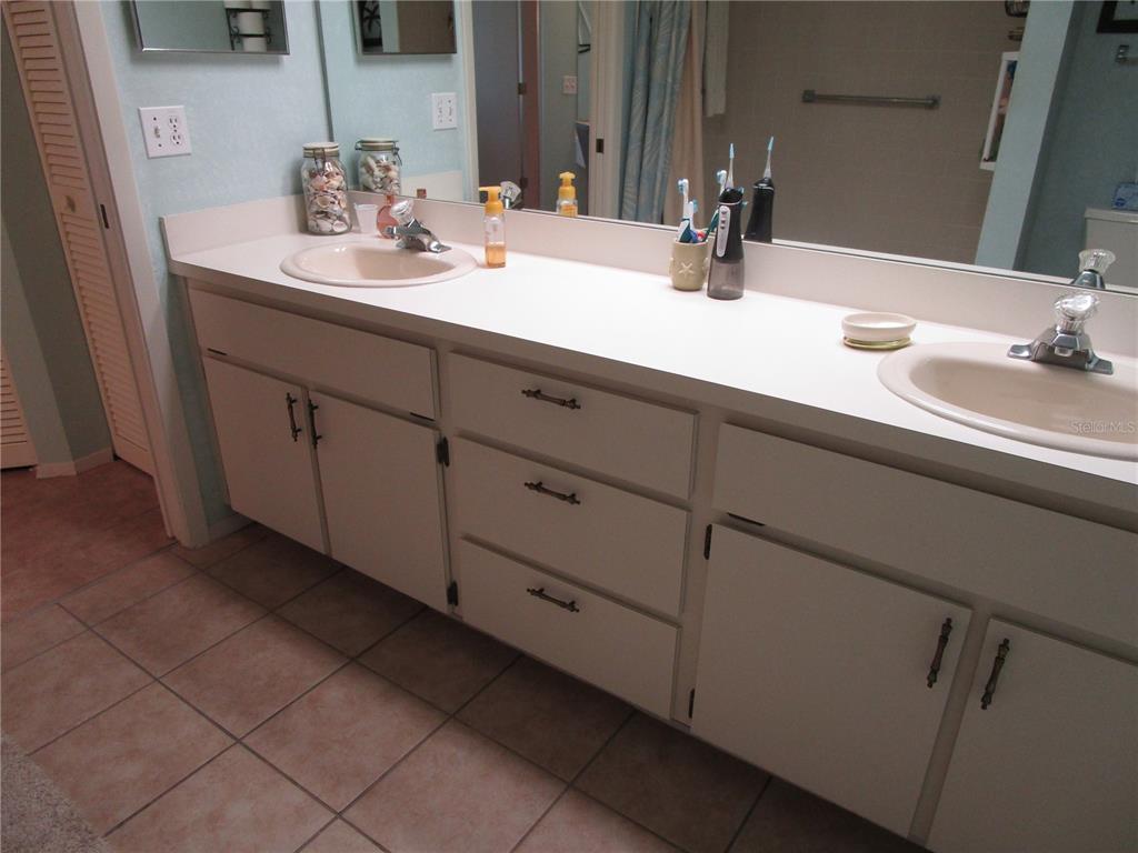 3968 Sailmaker Lane, Unit 3968 Holiday, FL 34691 - Photo 29 of 70 a bathroom with a double vanity sink and a mirror