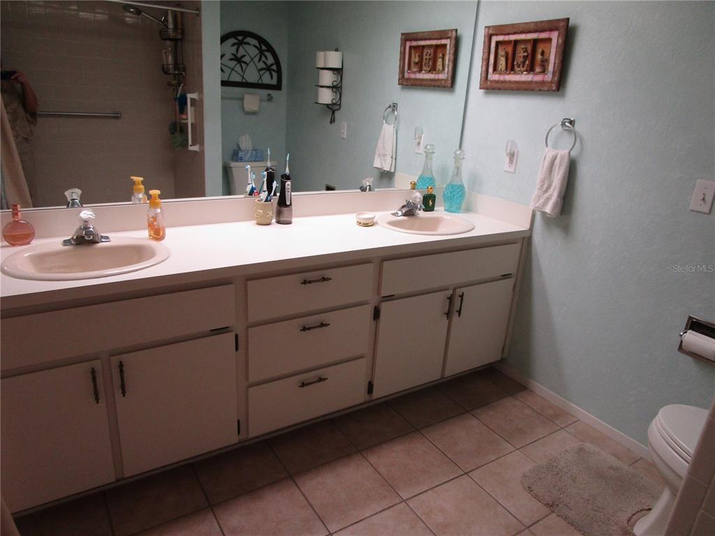 3968 Sailmaker Lane, Unit 3968 Holiday, FL 34691 - Photo 30 of 70 a bathroom with a double vanity sink and a mirror