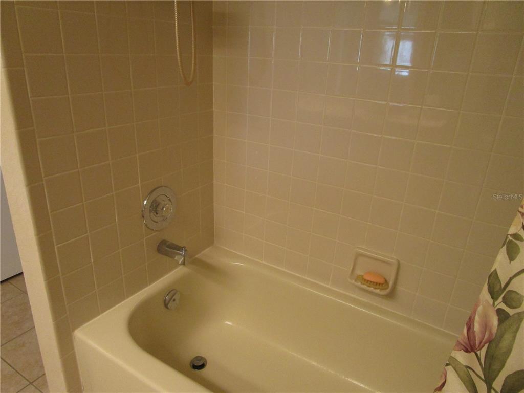 3968 Sailmaker Lane, Unit 3968 Holiday, FL 34691 - Photo 38 of 70 a bathroom with a tub