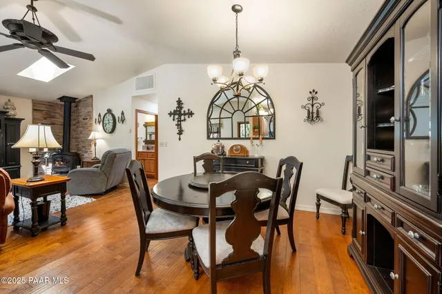 a view of a dining room with furniture wooden floor and chandelier