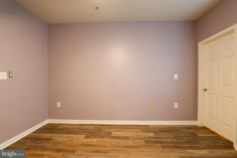 a view of a room with wooden floor and natural light